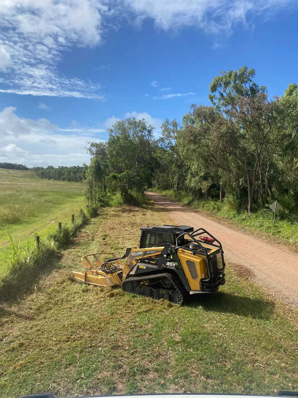 Brushcutter clearing a fence line