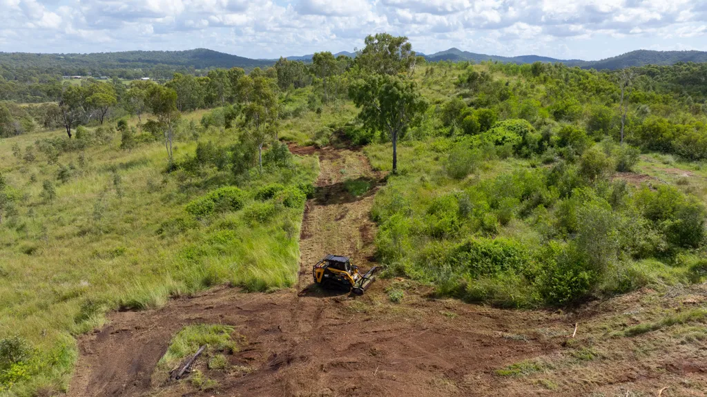 Aerial view of firebreak being cleared through dense vegetation
